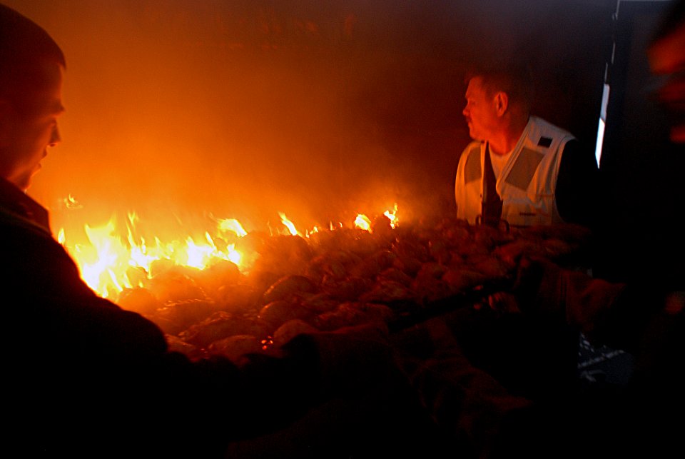 US Navy 080115-N-1688B-101 Sailors load chicken into an extra large smoker Bar-B-Q grill on elevator 4 in the hangar bay aboard the Nimitz-class nuclear-powered aircraft carrier USS Harry S. Truman (CVN 75)