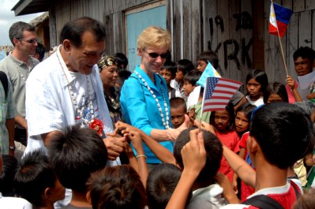 US Navy 080111-N-7286M-013 U.S. Ambassador to the Philippines Kristie A. Kenney and Zamboanga Mayor Celso Lobregat greet children in the Tigtabon Barungay during a visit to see the progress of a U.S. Agency for International De