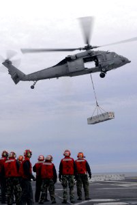 US Navy 080108-N-7526R-144 ailors watch as an MH-60S Seahawk, assigned to the