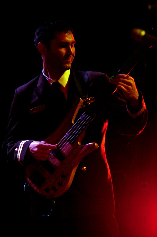 US Navy 080112-N-3659B-387 Lt. Jared Gianquinto, a dental officer assigned to the Nimitz-class nuclear-powered aircraft carrier USS Ronald Reagan (CVN 76), plays bass guitar with the band
