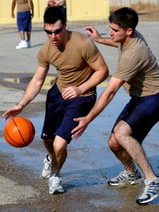 US Navy 080112-N-7367K-010 Builder 3rd Class Ryan Richards, assigned to Naval Mobile Construction Battalion (NMCB) 1, tries to dribble past Construction Mechanic 3rd Class Jacob Bockhorn in a basketball game during the detachme photo