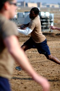 US Navy 080112-N-7367K-006 Builder 3rd Class Bryan Williams, assigned to Naval Mobile Construction Battalion (NMCB) 1, Task Force Sierra, scrambles out of a defender's reach in a two-hand-touch football game during the detachme