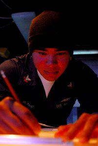 US Navy 080110-N-7526R-645 Operations Specialist 2nd Class Sergio Alarid makes a plot on a digital dead reckoning tracer (DDRT) while standing watch in sea combat aboard the Nimitz-class nuclear-powered aircraft carrier USS Ron