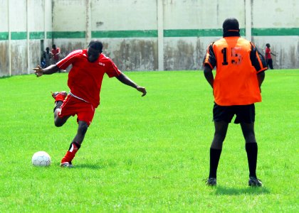 US Navy 080113-N-8933S-073 Engineman 3rd Class Lawrence Cofie, assigned to the amphibious dock landing ship USS Fort McHenry (LSD 43) as part of Africa Partnership Station (APS), plays soccer with local Gabonese soccer players