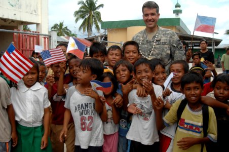 US Navy 080111-N-7286M-036 Col. William J. Coultrup, commander of the Joint Special Operations Task Force-Philippines, poses for photos with children in the Tigtabon Barungay