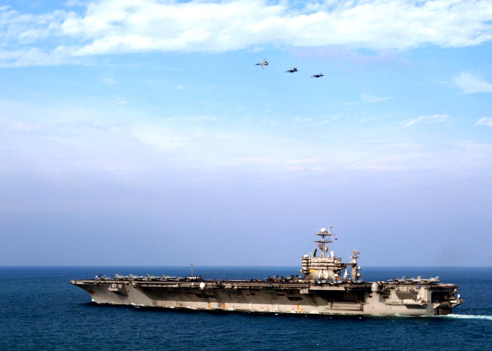 US Navy 080118-N-0535P-333 Three F-A-18 Hornets fly in formation over the Nimitz-class nuclear-powered aircraft carrier USS Harry S. Truman (CVN 75)