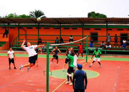 US Navy 080112-N-8933S-219 Lt. Cmdr. Thomas C. Kait, executive officer of the dock landing ship USS Fort McHenry (LSD 43), spikes during a volleyball game against the Vieille Gloire (Old Glory) team a local Gabonese volleyball