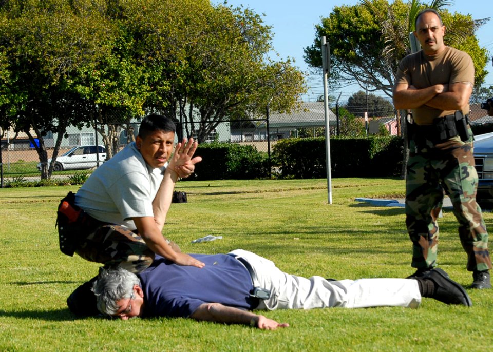 US Navy 080116-N-8607R-068 Department of Defense police and active duty and reserve service members subdue a suspect as part of the pepper spray certification course at Naval Base Ventura County