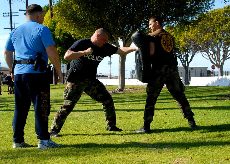 US Navy 080116-N-8607R-045 Department of Defense police and active duty and reserve service members fight each other during an obstacle course that tests how well they can defend themselves with impaired vision
