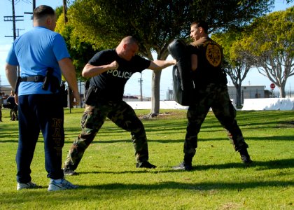 US Navy 080116-N-8607R-045 Department of Defense police and active duty and reserve service members fight each other during an obstacle course that tests how well they can defend themselves with impaired vision