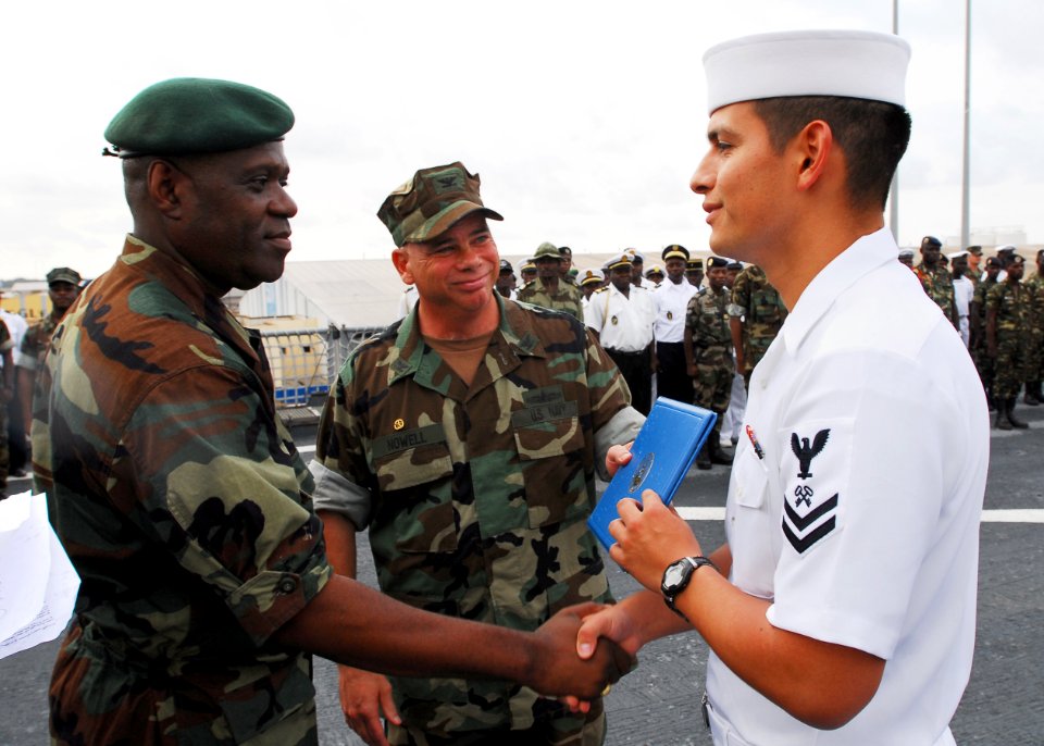 US Navy 080117-N-8933S-137 Capt. Paul Biving Nziengui, left, chief of the Gabonese National Navy, thanks Storekeeper 2nd Class Ronald Saucedo, right, for saving the life of a Gabonese civilian on Sogara Beach, Gabon