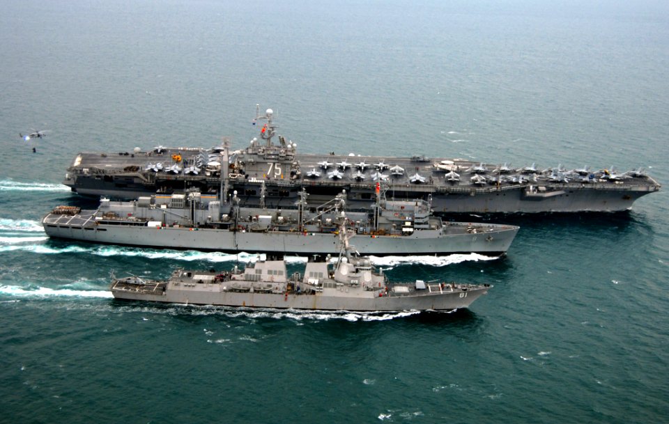 US Navy 080123-N-0535P-548 The aircraft carrier USS Harry S. Truman (CVN 75), top, performs a replenishment at sea with the fast combat support ship USNS Arctic (T-AOE 8) and the Arleigh Burke-class guided-missile destroyer USS