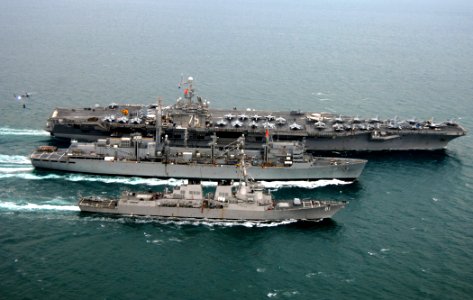 US Navy 080123-N-0535P-548 The aircraft carrier USS Harry S. Truman (CVN 75), top, performs a replenishment at sea with the fast combat support ship USNS Arctic (T-AOE 8) and the Arleigh Burke-class guided-missile destroyer USS