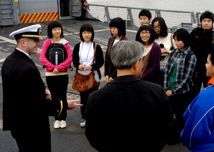 US Navy 080118-N-3285B-021 tudents from Hasan, Korea, listen as Ensign Jon Greenwald, force protection officer aboard the guided-missile frigate USS De Wert (FFG 45), gives background information about the ship