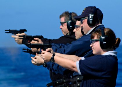 US Navy 080121-N-4649C-016 Sailors aboard the guided-missile cruiser USS Shiloh (CG 67) fire 9 mm handguns during small arms qualifications
