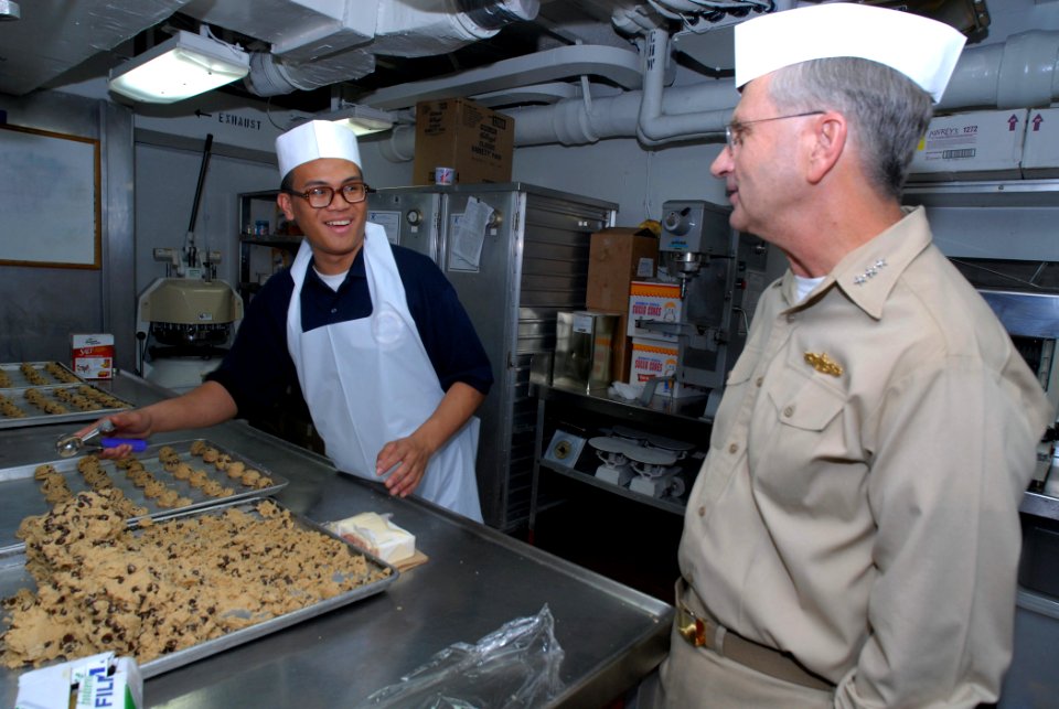 US Navy 080126-N-1113S-001 Vice Adm. Doug Crowder, right, talks with Culinary Specialist Seaman Emmauel Smith in the bakery aboard the amphibious command ship USS Blue Ridge (LCC 19)