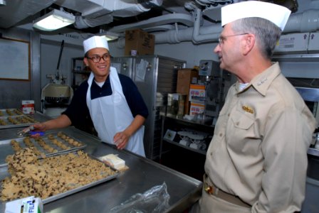 US Navy 080126-N-1113S-001 Vice Adm. Doug Crowder, right, talks with Culinary Specialist Seaman Emmauel Smith in the bakery aboard the amphibious command ship USS Blue Ridge (LCC 19)