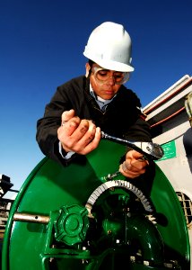 US Navy 080122-N-6538W-057 Aviation Boatswain's Mate 3rd Class Denver Constantino tightens bolts on an aquious film forming foam hose reel assembly on the flight deck of USS John C. Stennis (CVN 74)