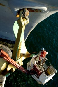 US Navy 080115-N-7883G-022 Boatswain's Mate Seaman Christopher Baker, from Haleyville, Ala., paints one of the two 30-ton anchors aboard the aircraft carrier USS Kitty Hawk (CV 63)