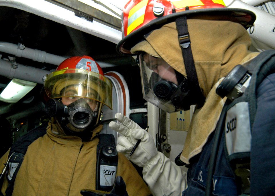 US Navy 080122-N-4649C-031 Crewmembers aboard the guided missile cruiser USS Shiloh (CG 67) exchange information during a main-space fire drill