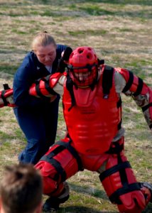 US Navy 080116-N-9520G-003 After she was sprayed with pepper spray during non-lethal weapons training, Fire Controlman 3rd Class Lacey Skidmore, left, assigned to the guided-missile destroyer USS Lassen (DDG 82), wrestles Gunne