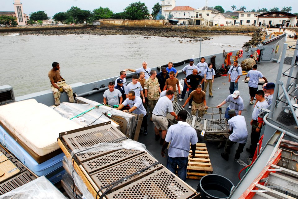 US Navy 080122-N-8933S-238 Africa Partnership Station (APS) Sailors move hospital beds from a landing craft utility to a local hospital designated from Project Handclasp