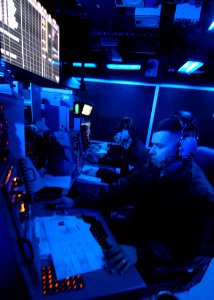 US Navy 080124-N-7981E-026 Lt. Jason Sparks stands watch as ship's weapons coordinator in the combat direction center aboard the Nimitz-class aircraft carrier USS Abraham Lincoln (CVN 72)