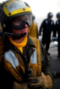 US Navy 080123-N-7981E-111 Aviation Boatswain's Mate 1st Class William Cunnyngham observes a recovery cycle during flight operations aboard the Nimitz-class aircraft carrier USS Abraham Lincoln (CVN 72) photo