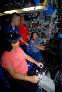 US Navy 080121-N-8534H-005 Command Master Chief Jim Lyle, chief-of-the-boat for the Los Angeles-class nuclear-powered attack submarine USS Pasadena (SSN 752), shows Olongapo city officials how submarines navigate when submerged