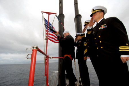 US Navy 080124-N-8534H-008 Sonar Technician (Submarine) 2nd Class Mike Micheli, assigned to the Los Angeles-class submarine USS Pasadena (SSN 752), renders a 13-gun salute during a burial at sea for retired Rear Adm. Eugene Flu