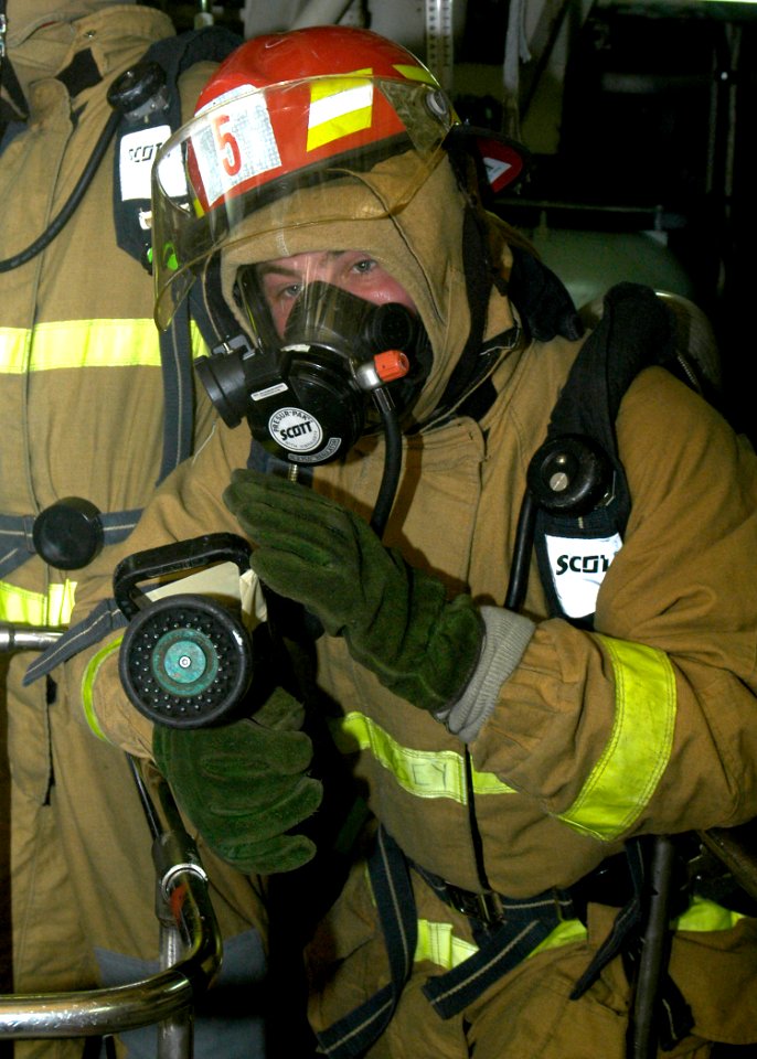 US Navy 080122-N-4649C-074 The nozzleman on a fire team simulates cooling a hot spot during a fire drill aboard the guided-missile cruiser USS Shiloh (CG 67)
