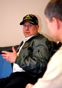 US Navy 080127-N-7981E-279 Secretary of the Navy (SECNAV) The Honorable Dr. Donald Winter speaks with Capt. James Loeblein, commodore of Destroyer Squadron (DESRON) 9 in the in-port cabin aboard the Arleigh Burke-class guided-m photo