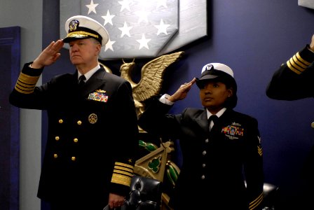 US Navy 080131-N-8273J-354 Adm. Gary Roughead, Chief of Naval Operations (CNO), and Yeoman 1st Class Tennille Hairston salute during the singing of the national anthem during a commissioning ceremony in the Hall of Heroes at th