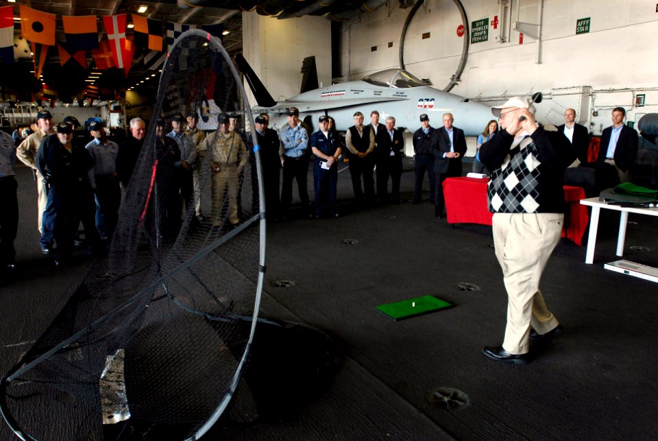 US Navy 080122-N-4776G-089 Professional golfer Billy Casper demonstrates his golf swing in the hangar bay of the Nimitz-class aircraft carrier USS Ronald Reagan (CVN 76)