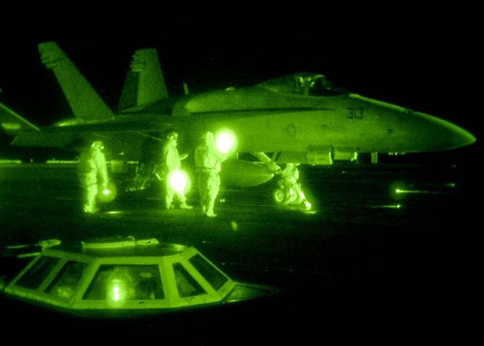 US Navy 080128-N-7571S-001 Flight deck personnel prepare an F-A-18 Hornet for launch aboard the aircraft carrier USS Theodore Roosevelt (CVN 71)