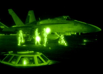 US Navy 080128-N-7571S-001 Flight deck personnel prepare an F-A-18 Hornet for launch aboard the aircraft carrier USS Theodore Roosevelt (CVN 71)