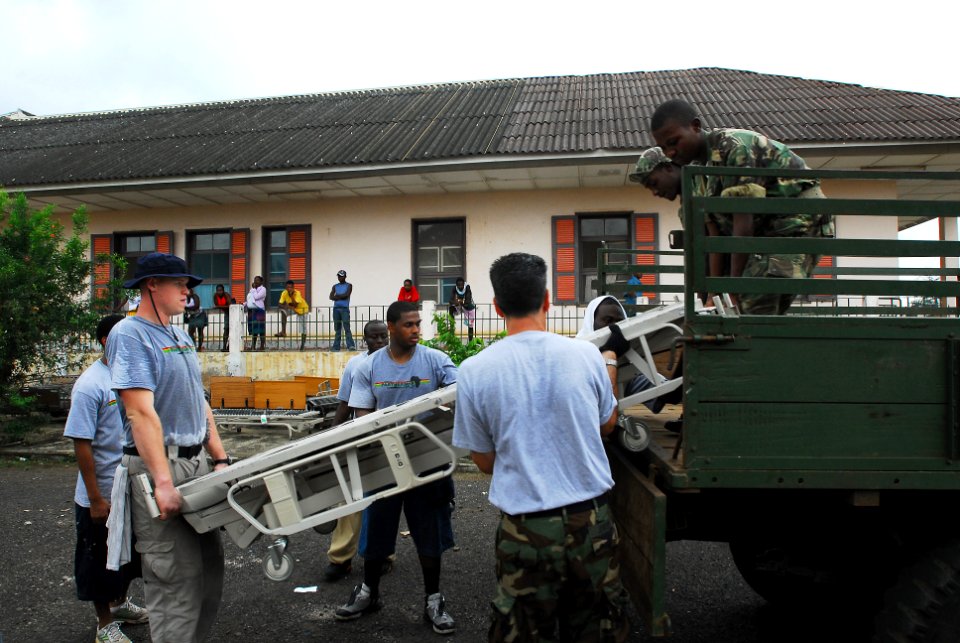 US Navy 080122-N-8933S-464 Africa Partnership Station (APS) Sailors and Sao Tomeain military personnel move hospital beds from a landing craft utility to a local hospital designated from Project Handclasp