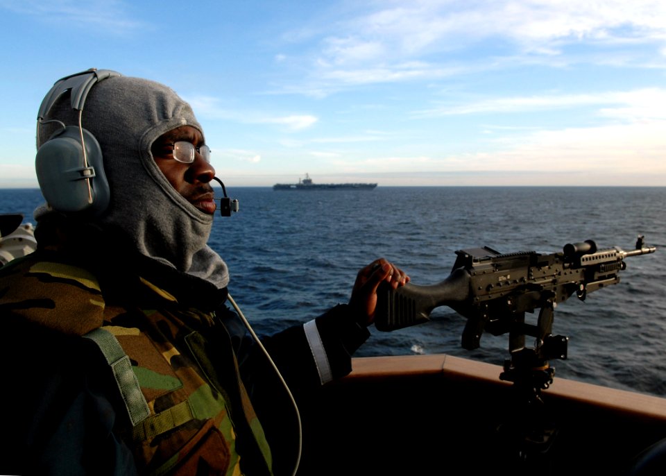 US Navy 080126-N-7981E-606 Gunner's Mate Seaman James Greer stands watch as part of the Small Craft Action Team aboard the guided missile cruiser USS Momsen (DDG 92) during a straight transit exercise