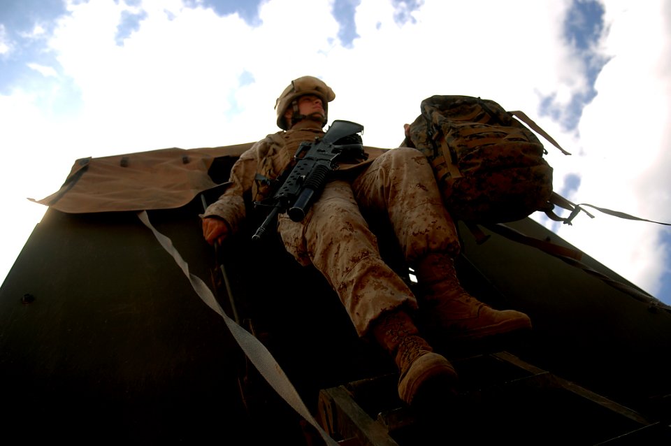 US Navy 080123-F-1644L-087 Lance Cpl. Michael Murray assigned to the 3rd Low Altitude Air Defense Battalion, Camp Pendleton, Calif. unloads from a seven-ton truck after arriving at the firing range