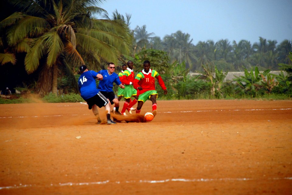 US Navy 080128-N-0193M-684 Sailors stationed aboard the high speed vessel (HSV) 2 Swift, in blue, and Togolese 1st Infantry Battalion, in red, battle it out for the ball in a friendly soccer game during the vessel's first port