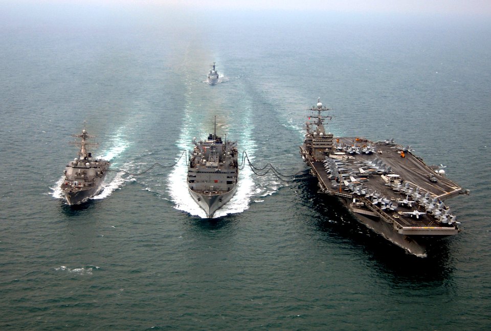 US Navy 080123-N-0535P-425 The Arleigh Burke-class guided-missile destroyer USS Winston S. Churchill (DDG 81), left, performs an emergency breakaway maneuver during a replenishment at sea