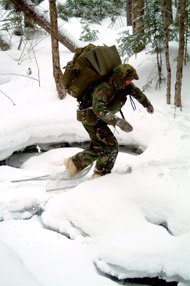 US Navy 080203-N-0411D-064 A student at the Navy Survival, Evasion, Resistance and Escape (SERE) school crosses a frozen creek