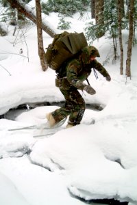 US Navy 080203-N-0411D-064 A student at the Navy Survival, Evasion, Resistance and Escape (SERE) school crosses a frozen creek