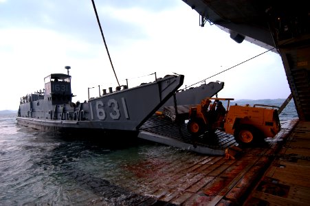 US Navy 080124-N-0807W-141 A forklift from the amphibious assault ship USS Essex (LHD 2) unloads supplies from Landing Craft Utility 1631