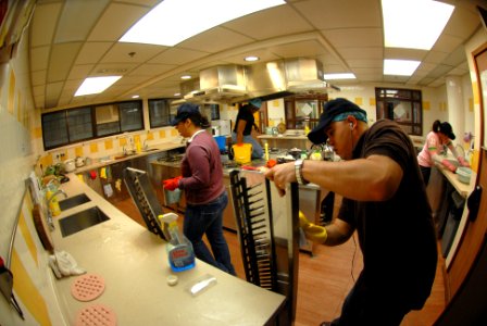 US Navy 080129-N-8546L-265 Ship's Serviceman 2nd Class Michael Ehle, assigned to the USS Blue Ridge, scrubs a ventilation dust trap in the kitchen of a Ronald McDonald House