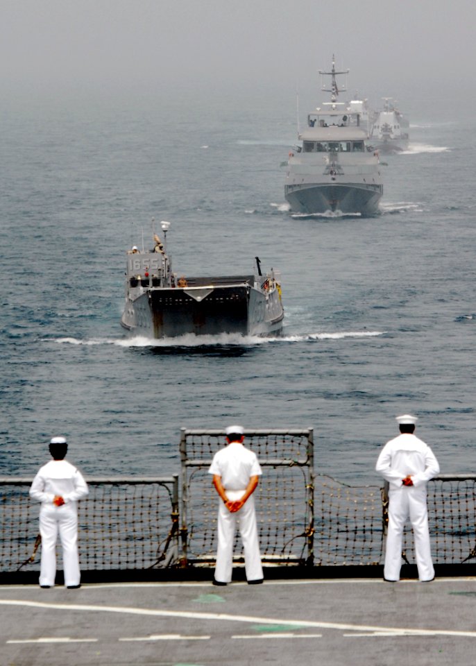 US Navy 080202-N-8933S-007 Africa Partnership Station (APS) Sailors watch as landing craft utility (LCU) 1655 leads a formation of the Equatorial Guinea Navy behind the APS flagship, the dock landing ship USS Fort McHenry (LSD