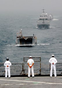 US Navy 080202-N-8933S-007 Africa Partnership Station (APS) Sailors watch as landing craft utility (LCU) 1655 leads a formation of the Equatorial Guinea Navy behind the APS flagship, the dock landing ship USS Fort McHenry (LSD