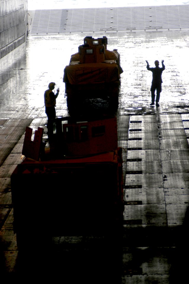 US Navy 080129-N-5642P-020 Marines direct vehicles to be loaded on landing craft air cushions (LCAC) in the well deck of the amphibious assault ship USS Kearsarge (LHD-3)