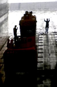 US Navy 080129-N-5642P-020 Marines direct vehicles to be loaded on landing craft air cushions (LCAC) in the well deck of the amphibious assault ship USS Kearsarge (LHD-3)