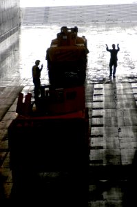 US Navy 080129-N-5642P-020 Marines direct vehicles to be loaded on landing craft air cushions (LCAC) in the well deck of the amphibious assault ship USS Kearsarge (LHD-3) photo